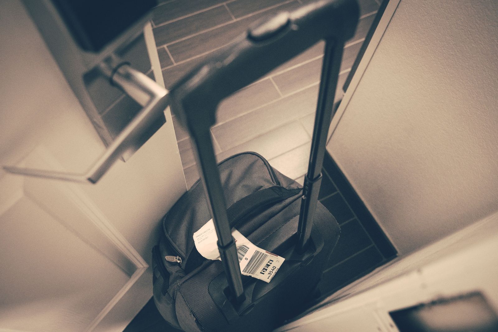 Suitcase waiting outside a guesthouse door for the morning luggage courier on the Camino Português