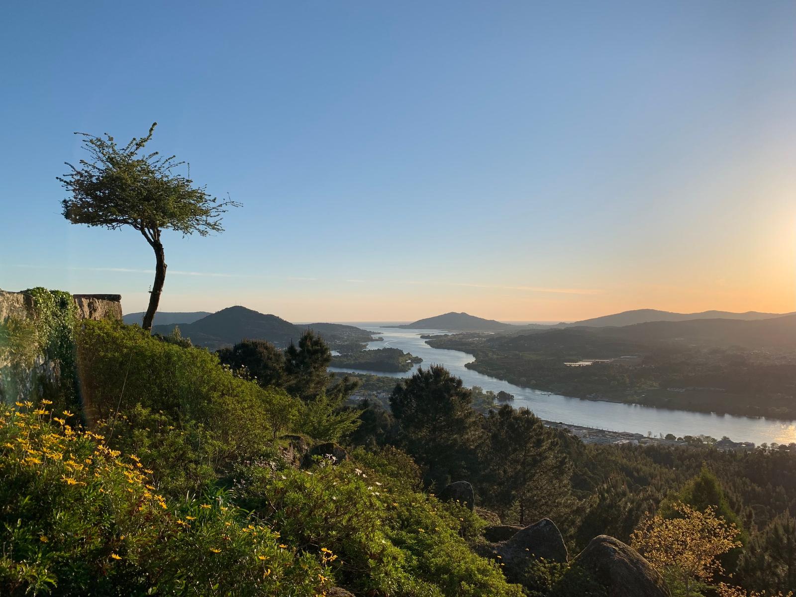 Sunset over the green hills and calm water of the Minho river on the border of Portugal and Spain