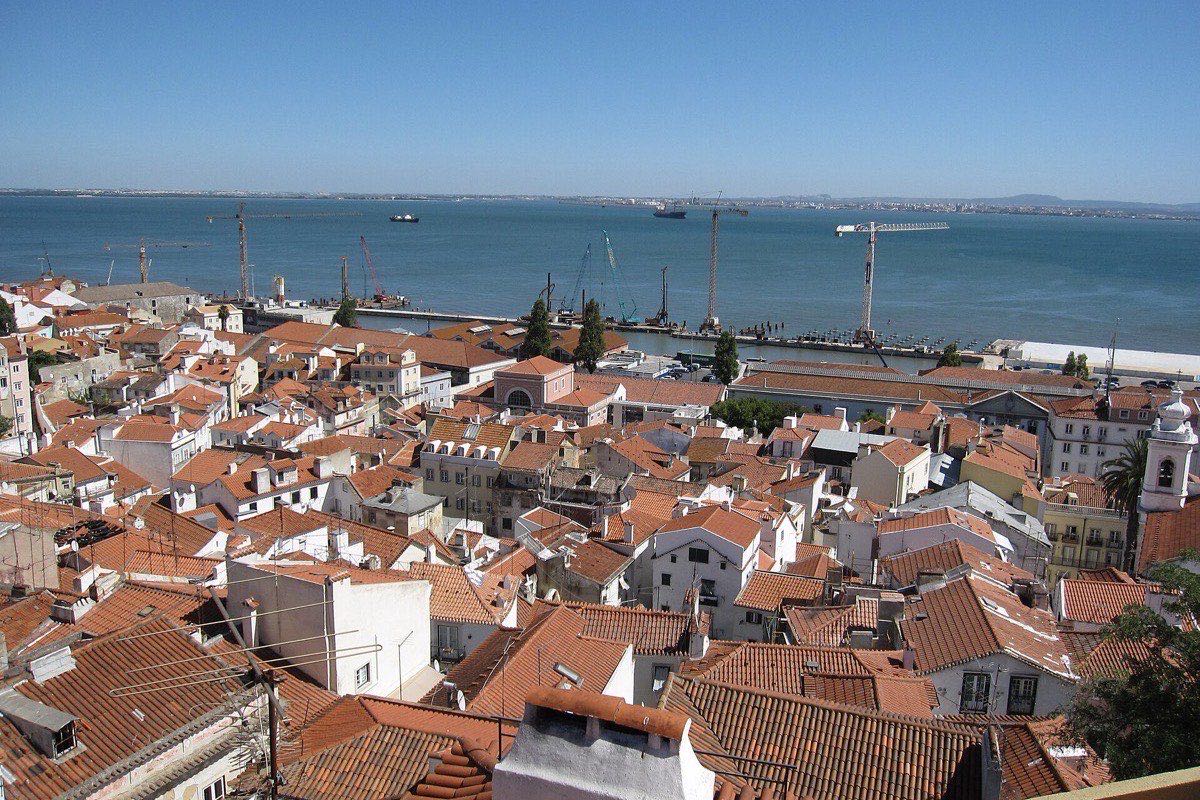 Terracotta rooftops of Alfama overlooking the Tagus river in Lisbon